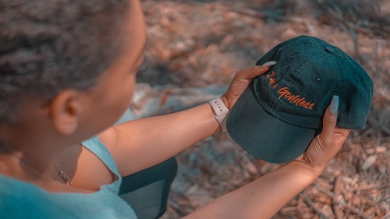 Woman holding Goddess ball cap